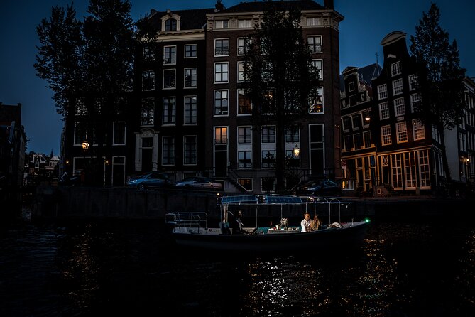 Amsterdam: Private Romantic Evening Canal Cruise + Bubbles/Snacks - Skinny Bridge under hundreds of lights